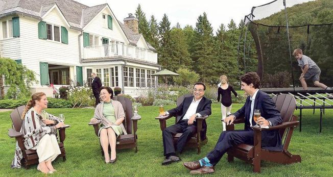 加拿大总理杜鲁多(前右一)与妻子索菲(前左一)以家宴接待李克强(前右二)及其夫人程虹(前左二)，饭后在室外小酌一杯，孩子们在后玩耍。 (取材自微博)
