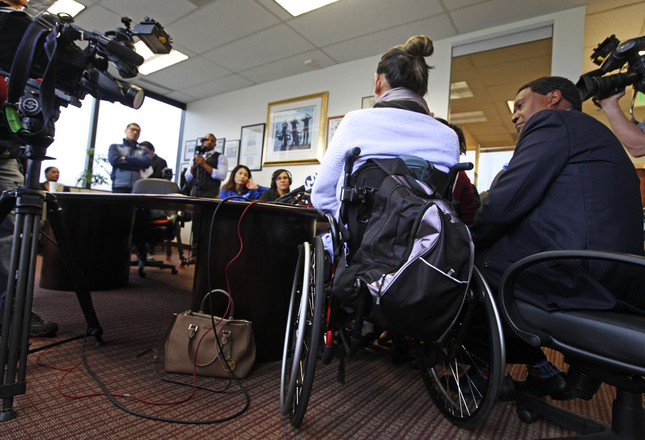 Hung Lam, who did not want his face photographed, answers questions from the media about his case of excessive force against the San Jose Police Department