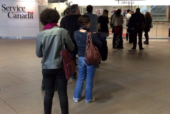 People wait for the Service Canada centre to open on April 2, 2014 in Montreal.
