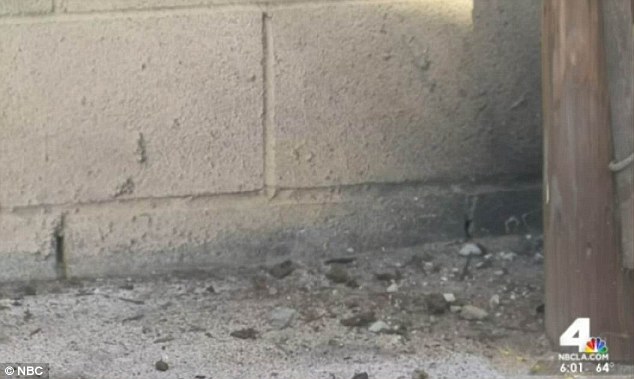 It exploded against a concrete wall that separated commercial buildings to the east and residences to the west
