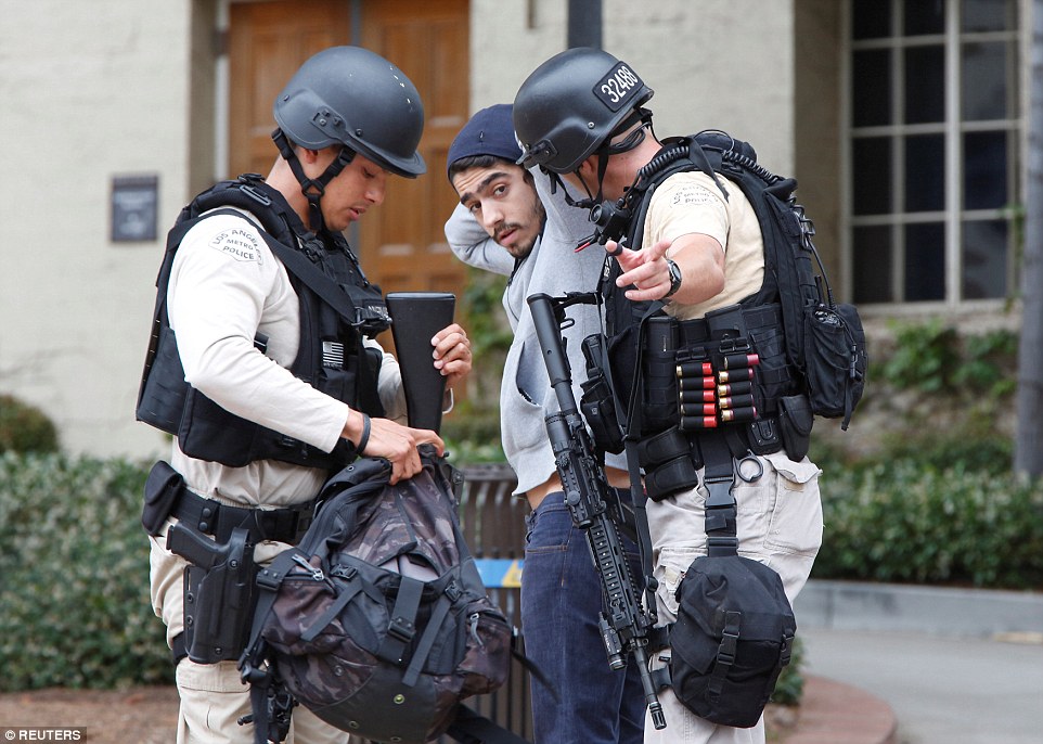 据早些时候报道说，官员正在寻找一位穿黑衣的男子时，但警方说，他们是不是在找另外的嫌疑人（如图，一个学生被警察搜查）