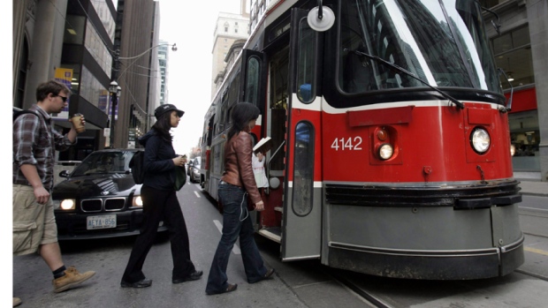 TTC commuters are being urged to wait until the streetcar has fully stopped before stepping onto the road, Toronto police say. 