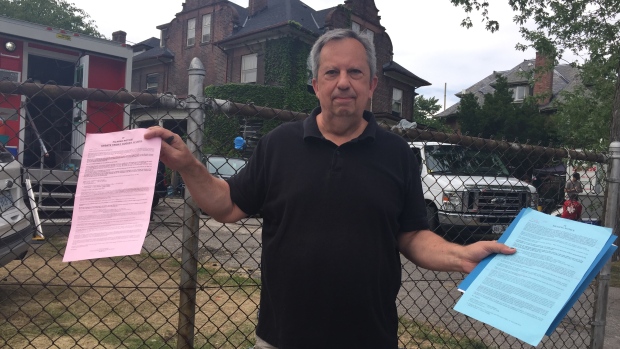 Nick Shcherban, shown here holding filming notices for the production of the movie version of the Stephen King novel It, says the film crew has trespassed on his property, littered and made excessive noise.