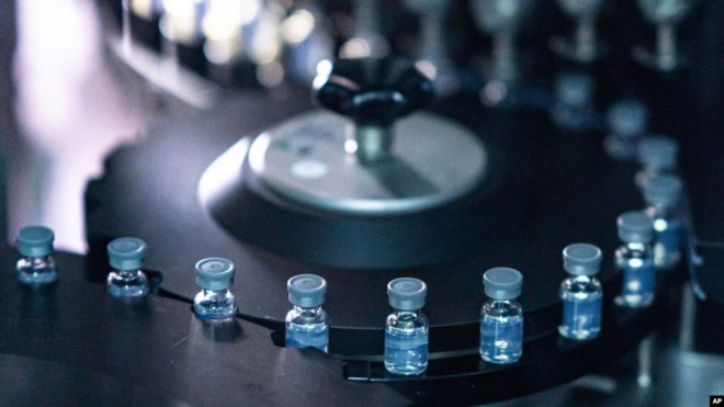 FILE - This August 2022 photo provided by Pfizer shows vials of the company's updated COVID-19 vaccine during production in Kalamazoo, Mich.