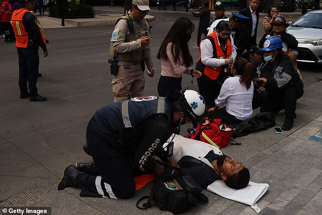 A paramedic gives medical assistance following the quake. There have been no major injuries reported as of yet