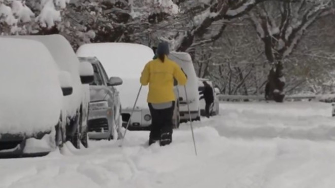 Someone is seen cross-country skiing on a snowy street in Vancouver, B.C., on Dec. 20, 2022. (Alissa Thibault)
