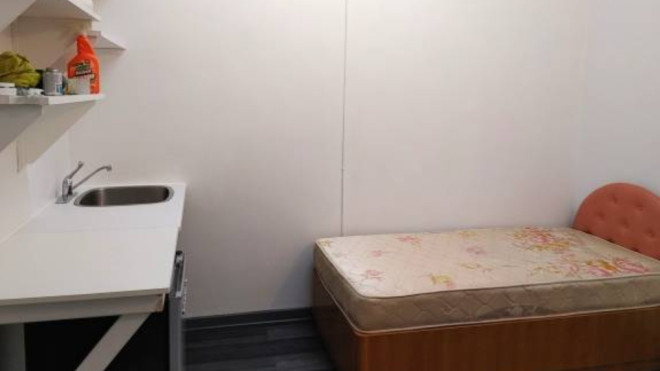 A single bed and kitchenette are seen in one of four photos included in an advertisement for a micro suite available for rent in Vancouver. (Craigslist)